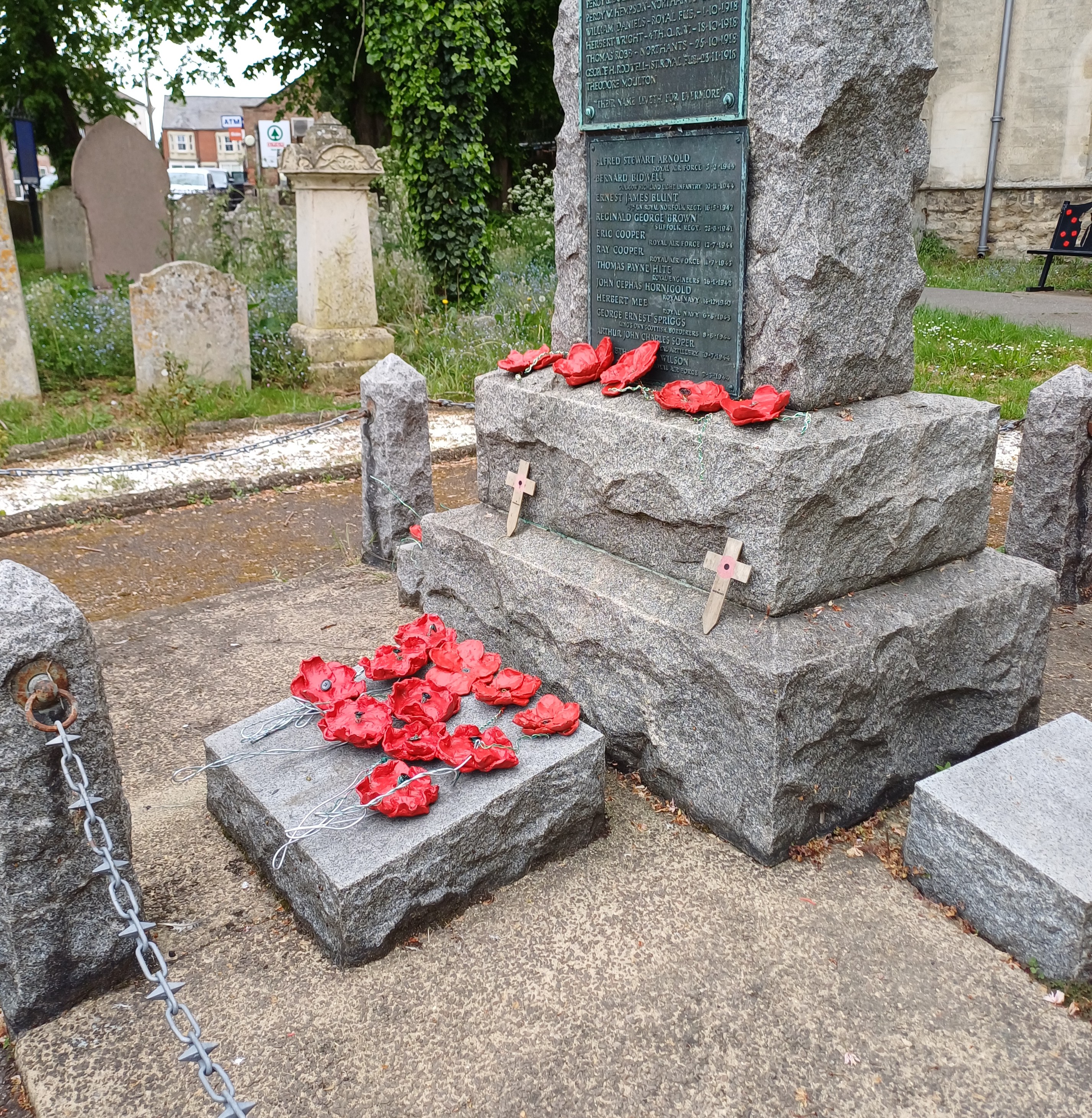 Clay poppies laid out on a war memorial. 